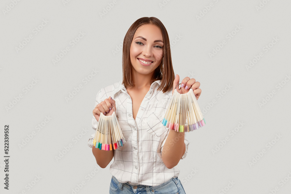 Beautiful young happy woman looking at camera holdin nail tips. Beauty portrait of brunette girl Beautiful young happy woman looking at camera holdin nail tips. Beauty portrait of brunette girl