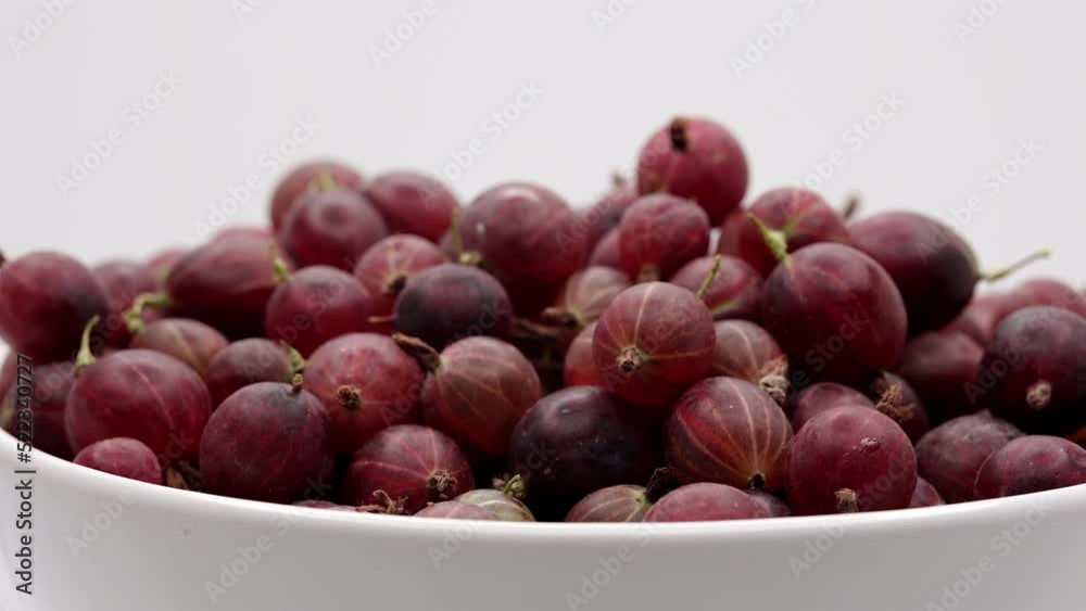 Gooseberry Fruit On A White Plate. Close Up. Fresh Red Gooseberries Spin On White Background. 60 FPS, 4k, ProRes