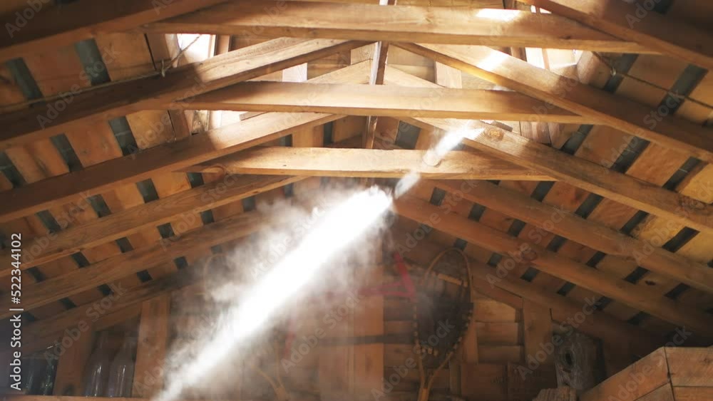 Sugar shack house with wood fire pan and iron kettle evaporator concentrating and evaporating steam at ceiling roof for production of maple syrup in Highland country, Virginia