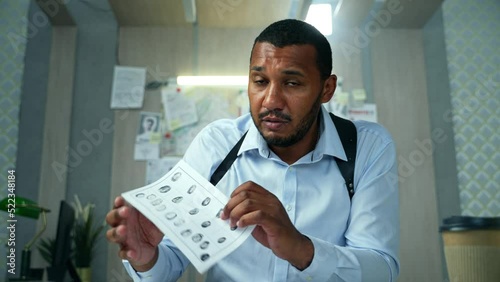 Detective having a video call about investigation with colleagues. Male police officer talking to web camera at laptop while telling the progress of the investigation to authority at police department