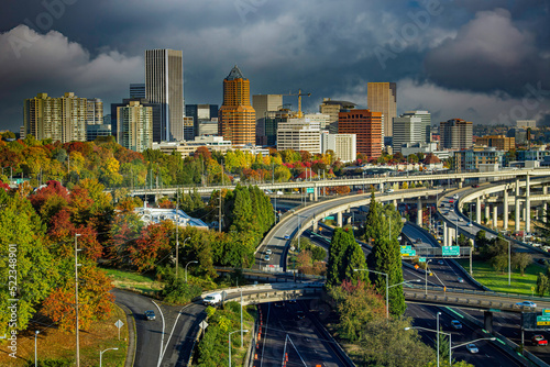 Downtown city of Portland Oregon with fall color trees and a freeway interchange in foreground
