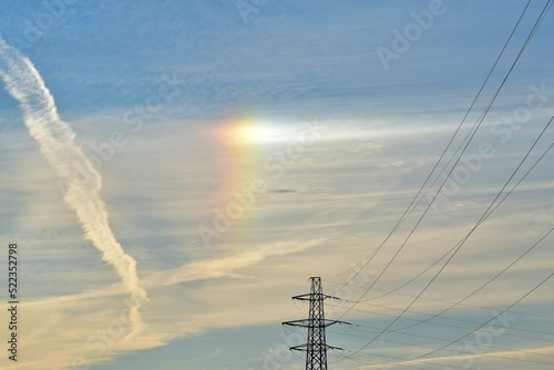 Fragment of a rainbow in the evening sky seen near electric lines, Coventry, West Midlands, England, UK