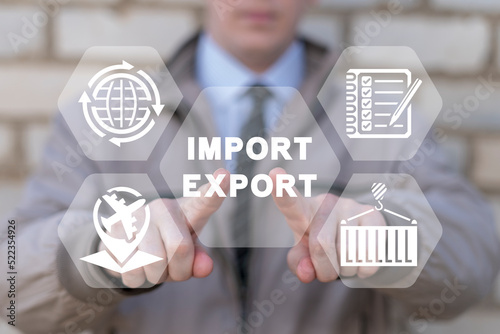 Concept of Import and Export. Global trade, shipping, distribution and logistics. Import of goods, export control. Businessman using virtual touchscreen presses on words: IMPORT EXPORT. photo