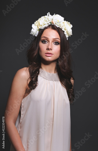 Portrait of a beautiful woman with flowers in her hair. Fashion