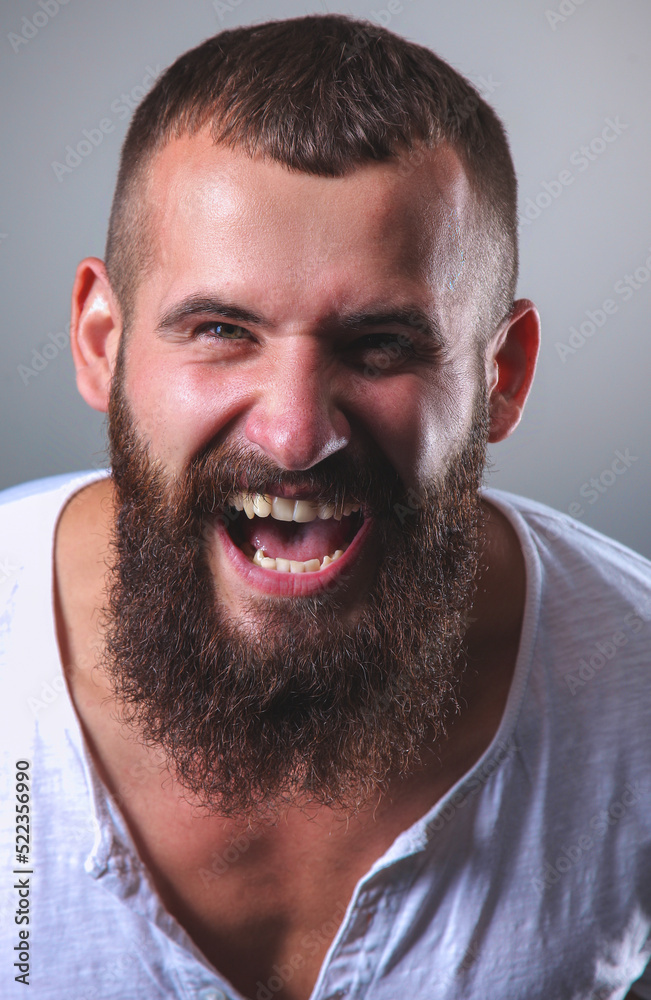 Fototapeta premium Portrait of handsome bearded man isolated on grey background
