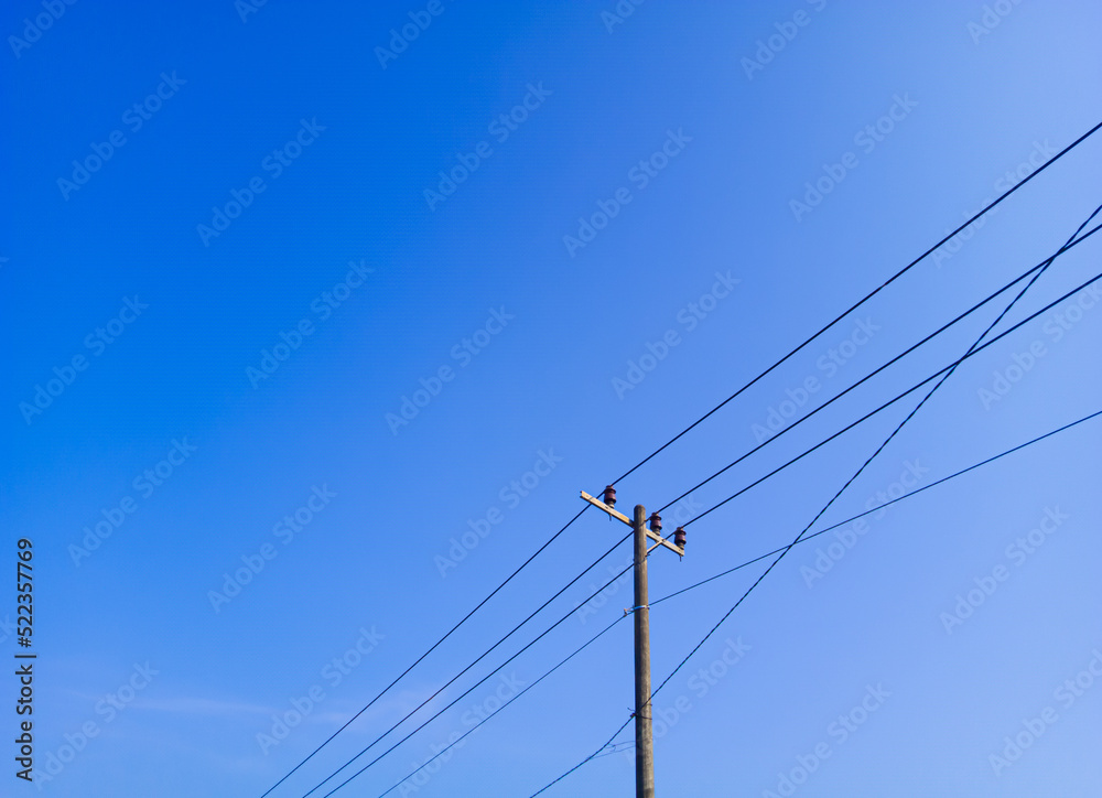 electric pole in a minimalist composition on a bright blue sky with empty space to enter text electric pole in a minimalist composition on a bright blue sky with empty space to enter text