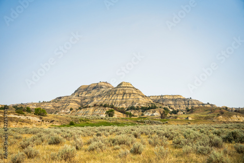 Wallpaper Mural Badlands Formation Rises Out Of Grassy Prairie