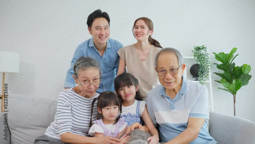 Portrait of Asian family spend leisure time with domestic cat together Portrait of Asian family spend leisure time with domestic cat together