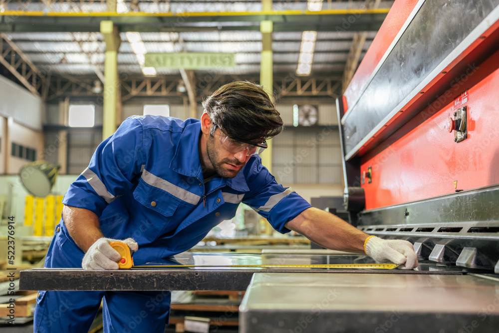 Caucasian handsome male industrial worker work in manufacturing plant. Caucasian handsome male industrial worker work in manufacturing plant.