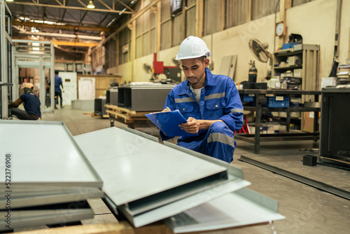 Asian attractive man industrial worker working in manufacturing plant.