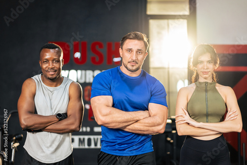 Portrait group of active athlete man and woman standing at fitness gym