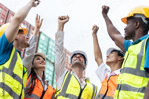 Group of young male and female worker working in container terminal. 