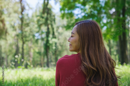 Portrait image of a young woman with closed eyes enjoying and relaxing in the park