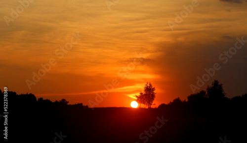 Photo of a bright sunset over the fields