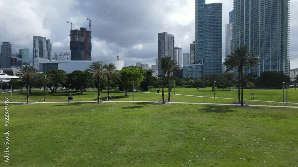 Aerial View, Downtown Miami USA Buildings Under Clouds and Maurice A Ferre Park, Flying Above Palm Trees and Grass Aerial View, Downtown Miami USA Buildings Under Clouds and Maurice A Ferre Park, Flying Above Palm Trees and Grass