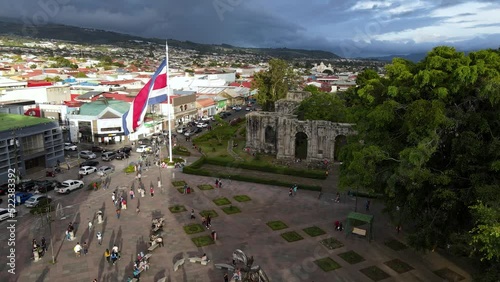 Beautiful aerial cinematic footage of the ruins, the CostaRican Flag, and the Bicentennial monument in Cartago Center  in Costa Rica photo