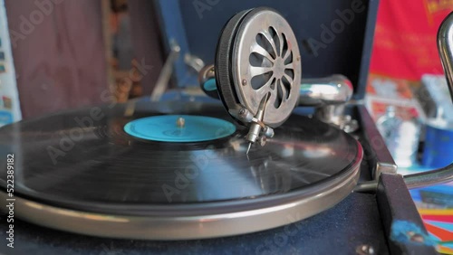 Close-up of vinyl record spinning in vintage retro player. Old gramophone phonograph player