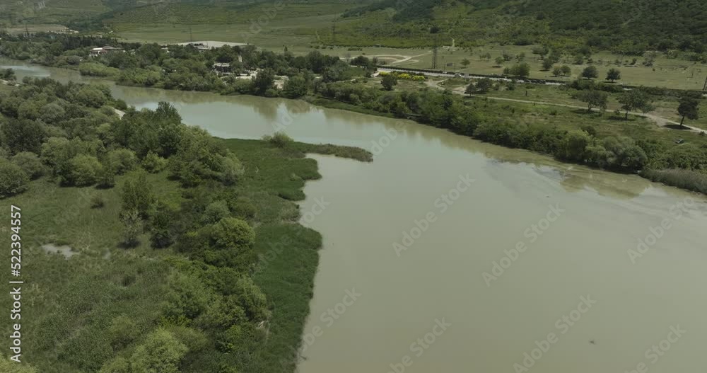 River Flowing Near Historical Town Of Mtskheta In Mtskheta-Mtianeti Province Of Georgia. Aerial Shot River Flowing Near Historical Town Of Mtskheta In Mtskheta-Mtianeti Province Of Georgia. Aerial Shot