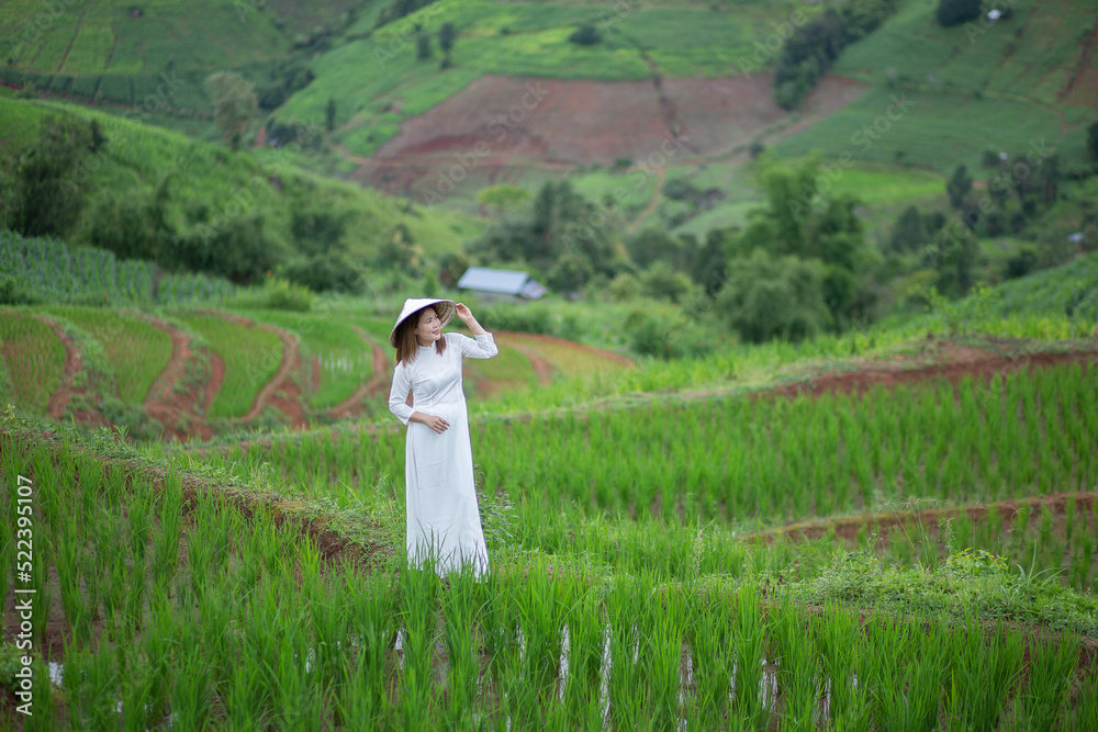 Asian beautiful woman with terraced green rice fields at Ban pa pong piang rice terraces of Chiang Mai, Thailand Asian beautiful woman with terraced green rice fields at Ban pa pong piang rice terraces of Chiang Mai, Thailand
