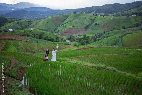 Asian beautiful woman with terraced green rice fields at Ban pa pong piang rice terraces of Chiang Mai, Thailand photo