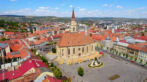 Aerial drone view of Saint Michael Church in Cluj, Romania. Cityscape, central square, old buildings, cars photo
