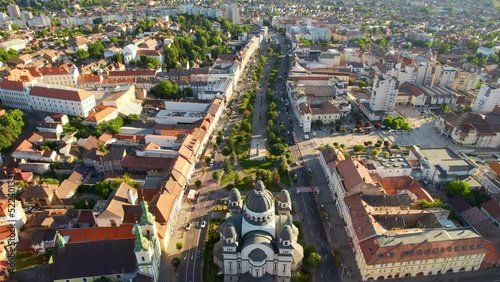 Aerial drone view of Ascension of the Lord Cathedral in the centre of Targu Mures, Romania. Old buildings, greenery, roads with cars