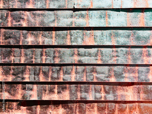 rusted tin metal wall factory building shed siding warehouse loading alley shipping container board ship dock