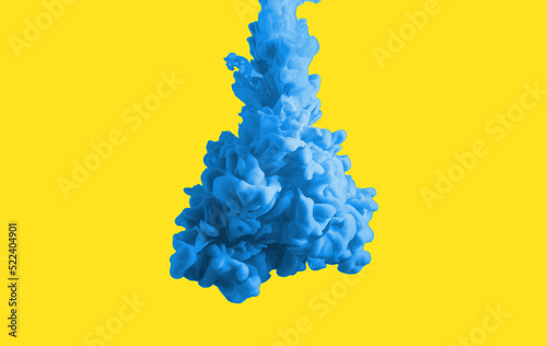 Blue paint clouds in water isolated on solid yellow background. Acrylic colors and ink in water. Abstract background. Bright colorful art. Copy space for banner, poster design. Ukraine colors