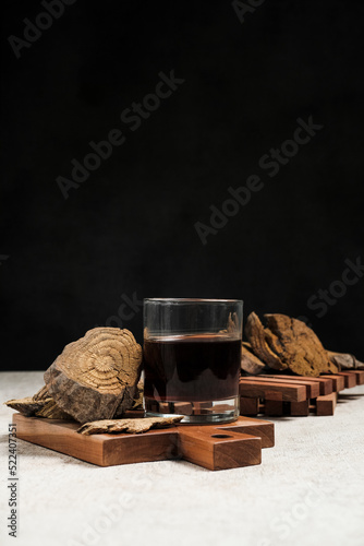 A glass of herbal drink with spices