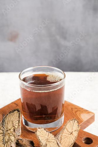 A glass of herbal drink with spices