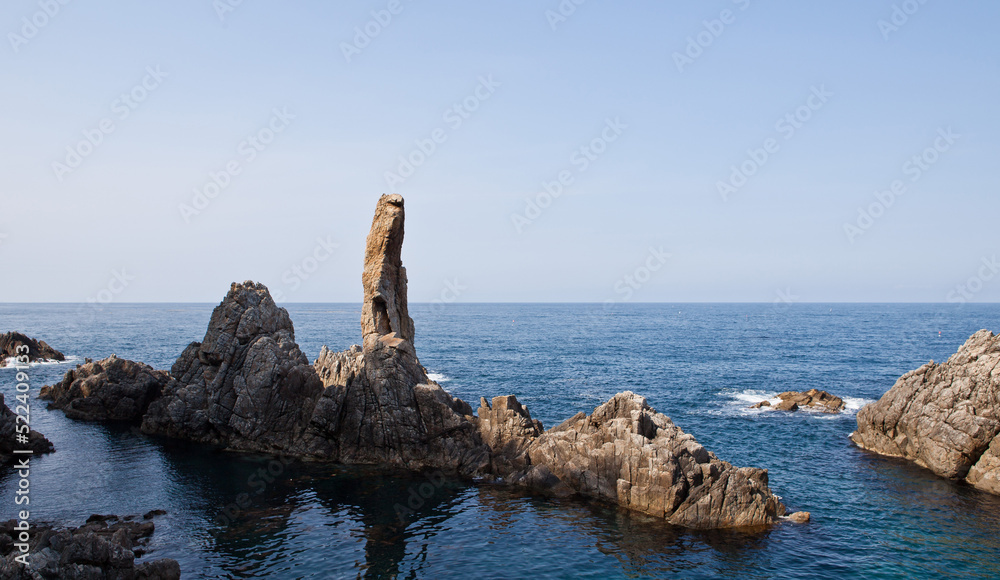 Ocean waves and strange rocks on the horizon Ocean waves and strange rocks on the horizon