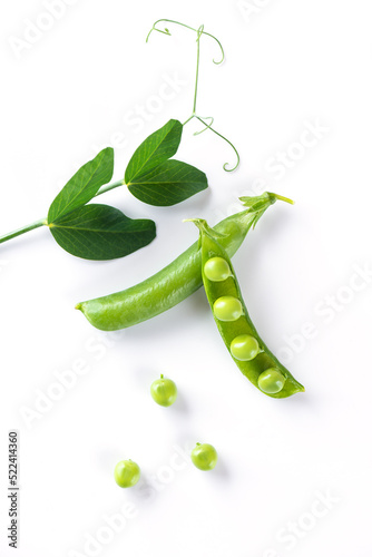 Ripe pea pods with green leaves on a white background.