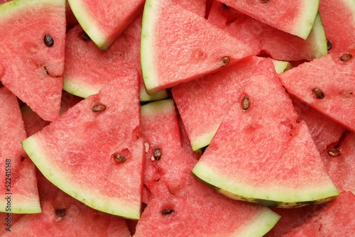 Slices of tasty ripe watermelon as background, top view
