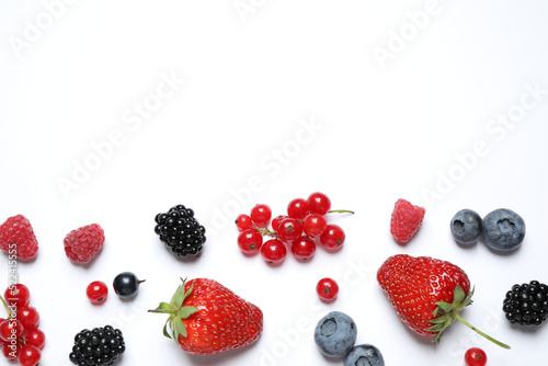 Mix of fresh berries on white background  flat lay