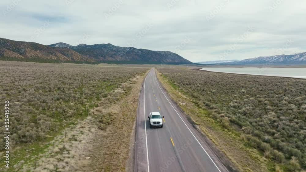 AERIAL - Truck on highway next to Scipio Lake, Utah, wide shot reverse AERIAL - Truck on highway next to Scipio Lake, Utah, wide shot reverse