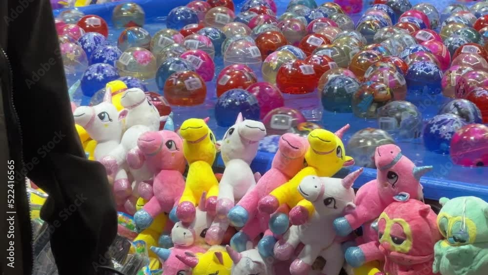 Catching the floating balls on the water to win a plush toy, popular