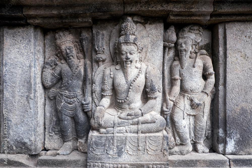 Carving Relief In Prambanan Temple. The temple is adorned with panels of narrative bas-reliefs telling the story of the Hindu epic Ramayana and Bhagavata Purana.