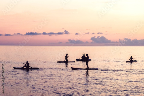 Travel.Silhouette man sea sup at sunset.outdoor travel.paddle standing, silhouette  man  beach  sunset. eco travel, taking care  your physical and mental health. Leisurely life and relaxation at sea. © shintartanya