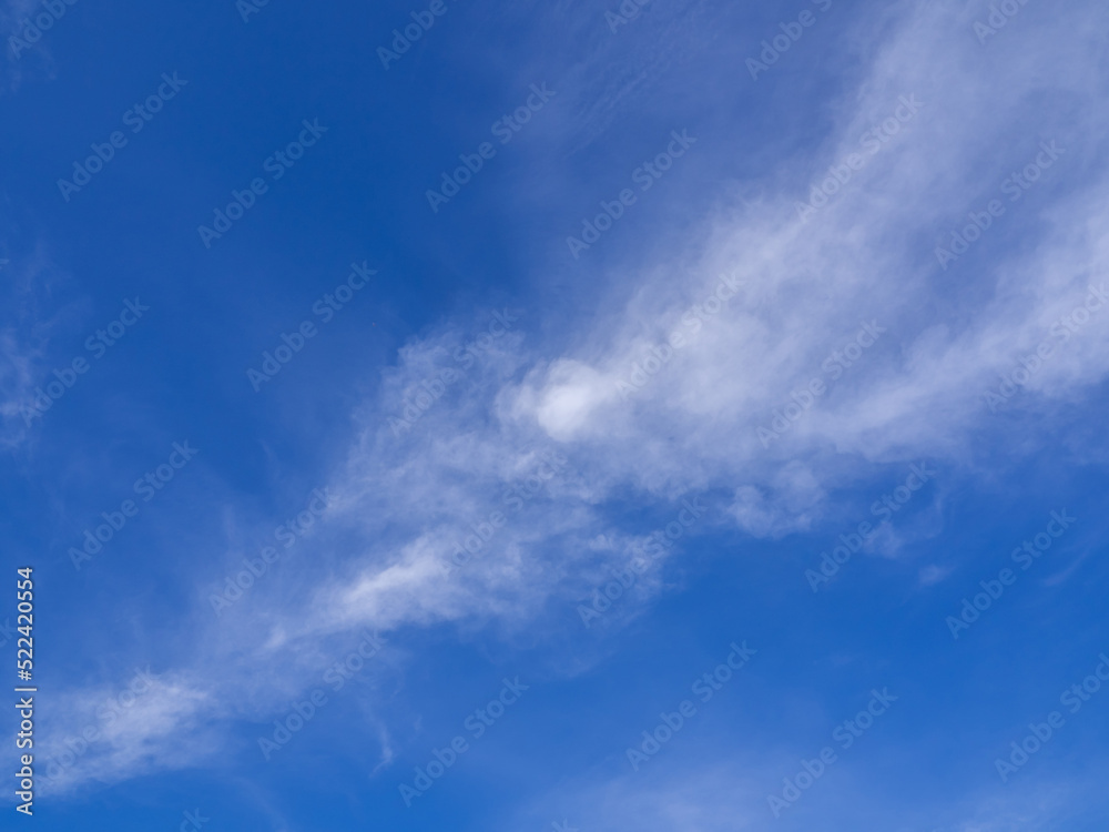 Faint clouds floating scattered across the sky Faint clouds floating scattered across the sky