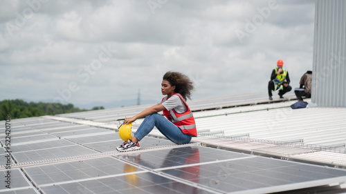 Construction workers clean solar panels for energy.Renewable Energy Battery Clean Mountain Climber Activities Work Uniforms.Managers discuss electric power ecology  human  renewable energy. 