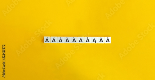 Accents and Diacritical Marks Banner. Letter Tiles on Yellow Background. Minimal Aesthetics. photo