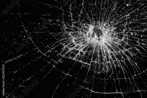 Broken glass texture on black background. Abstract of cracked screen smartphone from shock.