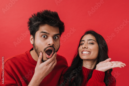 Young indian couple expressing surprise while posing together
