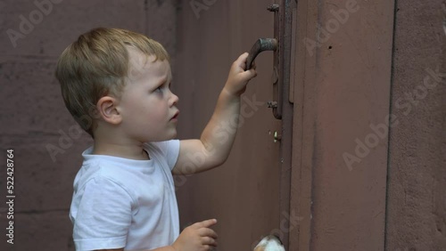 Kid Trying to Open Iron Door
