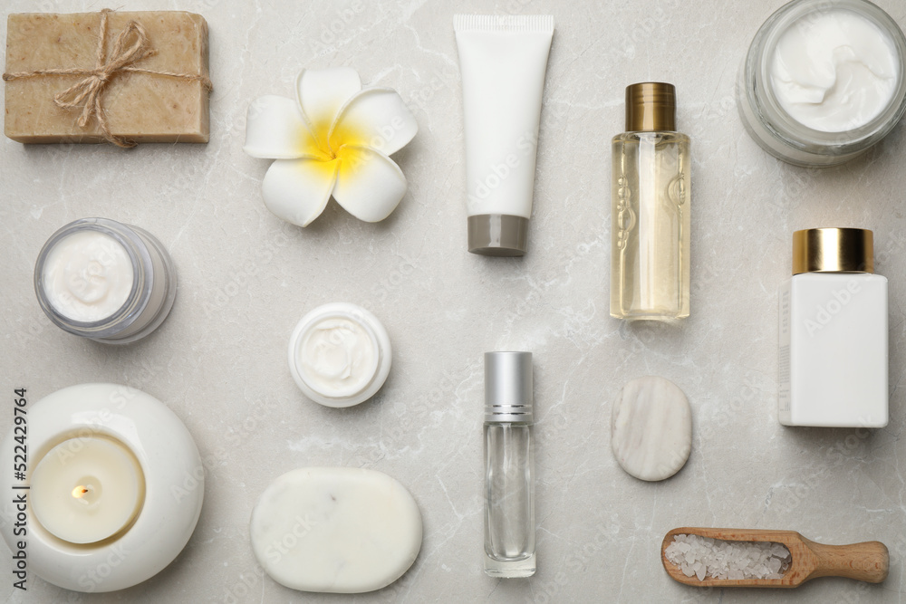 Flat lay composition with cosmetics and sea salt on grey marble table. Spa treatment Flat lay composition with cosmetics and sea salt on grey marble table. Spa treatment