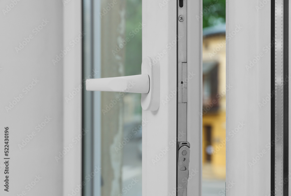 Open window with white plastic frame indoors, closeup Open window with white plastic frame indoors, closeup