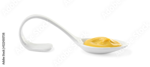 Mustard in ceramic serving spoon isolated on white