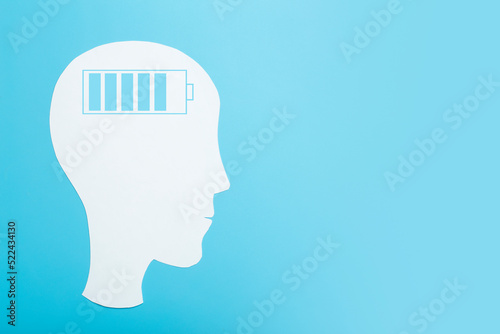 Brain charge concept. Brain energy charging indicator on paper-cut head. mental health idea