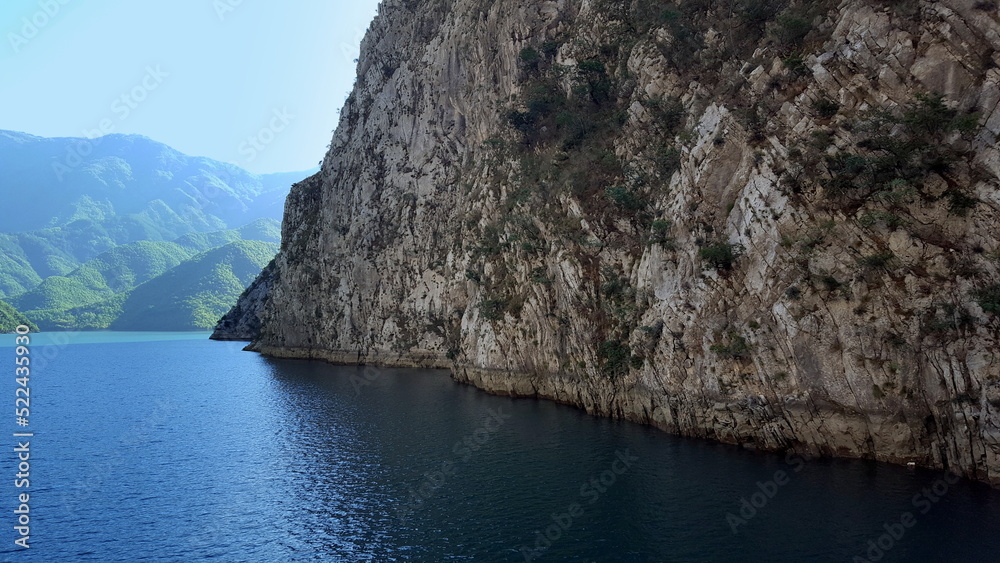 Albania, Lake Koman is a reservoir on the Drin River in northern Albania, surrounded by dense forested hills, vertical slopes, deep gorges and a narrow valley