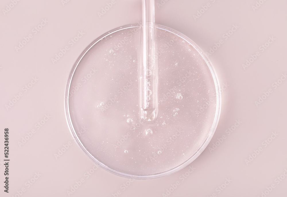 glass pipette serum gel closeup in petri dish on beige background glass pipette serum gel closeup in petri dish on beige background